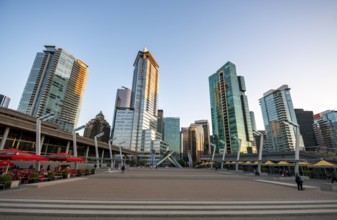 Olympic Cauldron Statue, Jack Poole Plaza Square, skyscrapers on the promenade at sunset, Coal