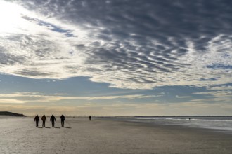 Walkers on the Wadden Sea near the East Frisian island of Spiekeroog, west of the North Sea island,