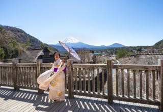 Japanese woman in kimono with umbrella, Iyashinosato open-air museum, old Japanese village with