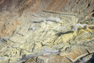 Steaming fumaroles in the Owakudani geothermal area at Komagatake volcano, Hakone, Japan