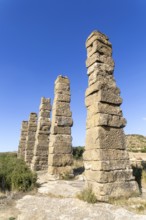 Stone columns of ancient aqueduct, Roman site of Los Banales, near Layana, Zaragoza province,
