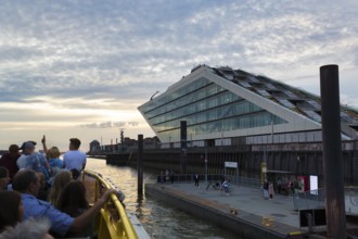 Harbour ferry line 62 with passengers on the Elbe, harbour cruise at sunset, Docklands, Hamburg,