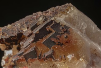 Transparent crystals sit on rocks and reveal their unique shimmer and geological structure. The