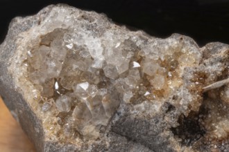 Vibrating quartz crystals mix with rock formations and capture light in a natural spring atmosphere