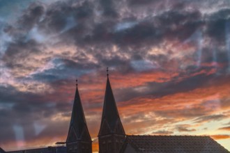 Church towers against dramatic evening sky at sunset, Nettetal