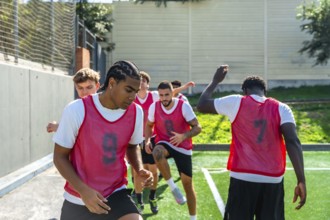 Group of diverse male soccer players engaging in intense drills and warm up exercises on an