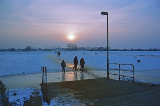 People walk across frozen Elbe, ferry dock, Neu Bleckede, Bleckede, Lower Saxony, Germany, February