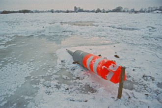 Buoy lying on ice rink, frozen Elbe, Bleckede, Lower Saxony, Germany, January 03, 1997, vintage,