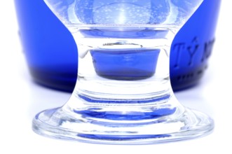 Glass with mineral water, small carbonated pearls on the edge of the glass, drinking water