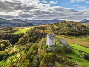 Autumn colours over Castell Dolwyddelan and Eryri Mountains from a drone, Snowdonia, Conwy County