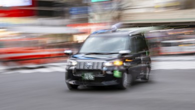 Black taxi driving, motion blur, long exposure, Shubuya Crossing, Shibuya, Tokyo, Japan