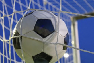 Soccer symbol: close-up of a soccer ball under floodlights