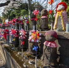 Jizo statues with red crocheted caps, guardian deities for deceased children, Unborn Children