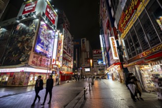 Street with illuminated shops and neon signs at night in Akihabara, Electric City, Tokyo, Japan
