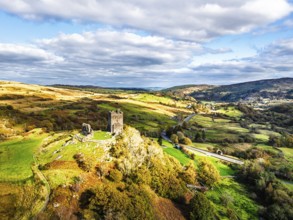 Autumn colours over Castell Dolwyddelan and Eryri Mountains from a drone, Snowdonia, Conwy County