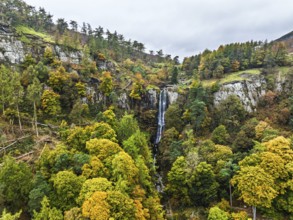 Autumn colours over Pistyll Rhaeadr Waterfall and Berwyn Mountains from a drone, Oswestry,