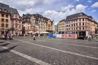 Square made of paving stones and marble slabs with pattern, row of houses, reconstructed historic