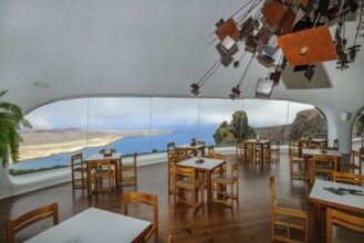 Interior of café with panoramic window in building designed by Cesar Manrique with the