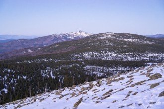 View from Mount Lusen over the hills of the bavarian forest at sunrise in winter, Bavaria, Germany