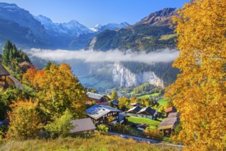 View from the village of the Lauterbrunnen Valley with Staubbach waterfall in autumn with morning