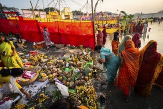 Hindu devotees gather on the banks of the Brahmaputra River to offer prayers to the Sun God on the
