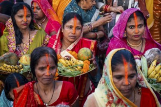 Hindu devotees offer prayers to the Sun God on the bank of Brahmaputra river on the occasion of