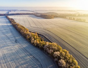 Bird Eye Perspective of Frost Covered Farmland. Seasonal Agricultural Scenery, winter and autumn