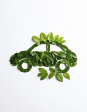 Car formed by green leaves and branches. Sustainable Car technology, ecology concept in harmony