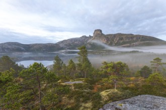 Magical morning fog on Steigtindvatnet in front of the majestic Steigtinden in Norway near Bodø