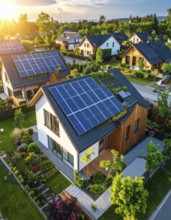 Aerial view showcases modern houses with solar panels and green roofs in a suburban setting,