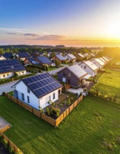 Aerial view showcases modern houses with solar panels and green roofs in a suburban setting,