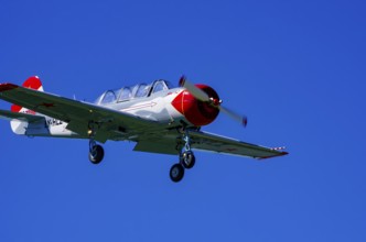 A Jakovlev Jak-52 with registration LY-HLZ during a flight demonstration as part of an air show on