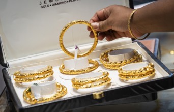 Customers purchase Gold jewelry at a store on the occasion of the festival of Dhanteras, in