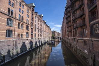 Canal between red brick buildings, warehouses in Hamburg's Speicherstadt, Hamburg, Germany