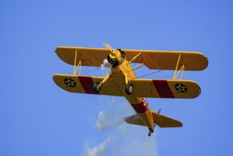 A Boeing-Stearman biplane during a flight demonstration as part of an air show at the Rossfeld in