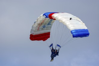 Two parachutists during an aerial acrobatic performance as part of an air show at the Rossfeld in