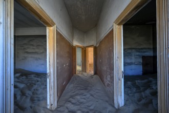 Sand mountains in a former dwelling house, interior photograph, Kolmanskop, restricted diamond