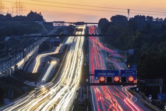 Motorway near Stuttgart with several lanes in the evening with sunset. Heavy traffic with light