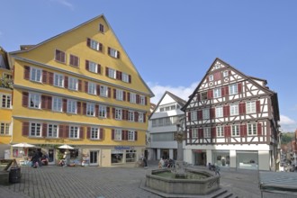 Yellow half-timbered house built in the 16th century, half-timbered houses and Georgsbrunnen,