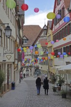 Houses in the Marktgasse with colourful lanterns, decoration, balloons, pedestrians, city museum,