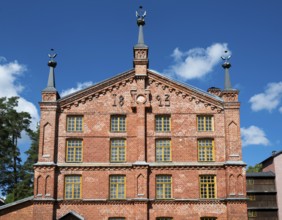 Multi-storey brick façade with inscription 1893, former paper factory and mill for the production