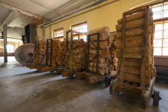 Carts with sawn logs for further processing, former paper factory and mill for the production of