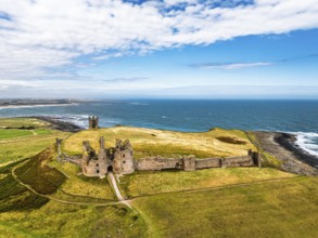 Dunstanburgh Castle from a drone, Northumberland Coast, England, United Kingdom