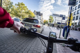 Cycling in the city, city centre road, cycle lane, two-wheeled traffic has priority, 30 km/h zone,