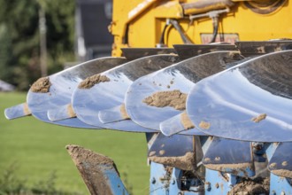 Plough, for ploughing a field, field, ploughshares, agricultural technology, shiny stainless steel,