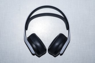 Top shot of a Playstation 5 headphone on a white Resopal plate
