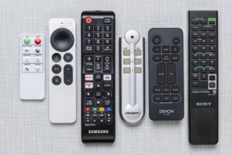 Top shot of a series of remote controls on a white Resopal panel