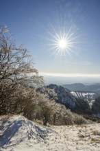View over the hills and valleys from the mountain with hoarfrost on the branches in winter, Vápec,