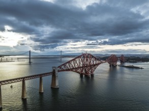 Rain clouds over Forth Bridge from a drone, Queensferry Crossing, Forth Estuary, Scotland, United