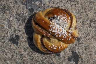 Kanelbulle or cinnamon bun with sugar, Swedish pastry speciality, Sweden